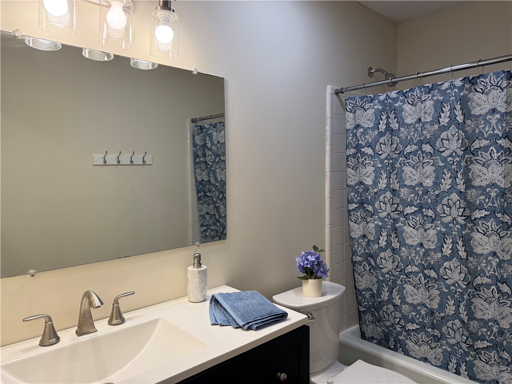 1507 East Calhoun Street Anderson, SC 29621 - Photo 10 of 18 A well-lit lavatory features a crisp white vanity and coordinating fixtures.