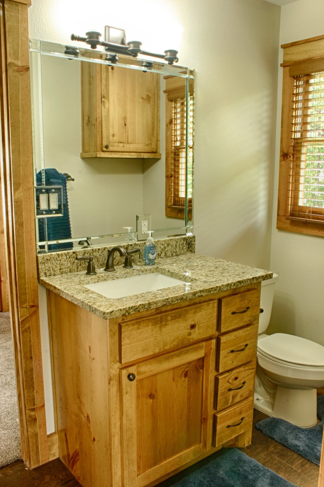 91 Bluejay Way Cleveland, TX 77327 - Photo 26 of 35 a bathroom with a granite countertop sink toilet and a mirror