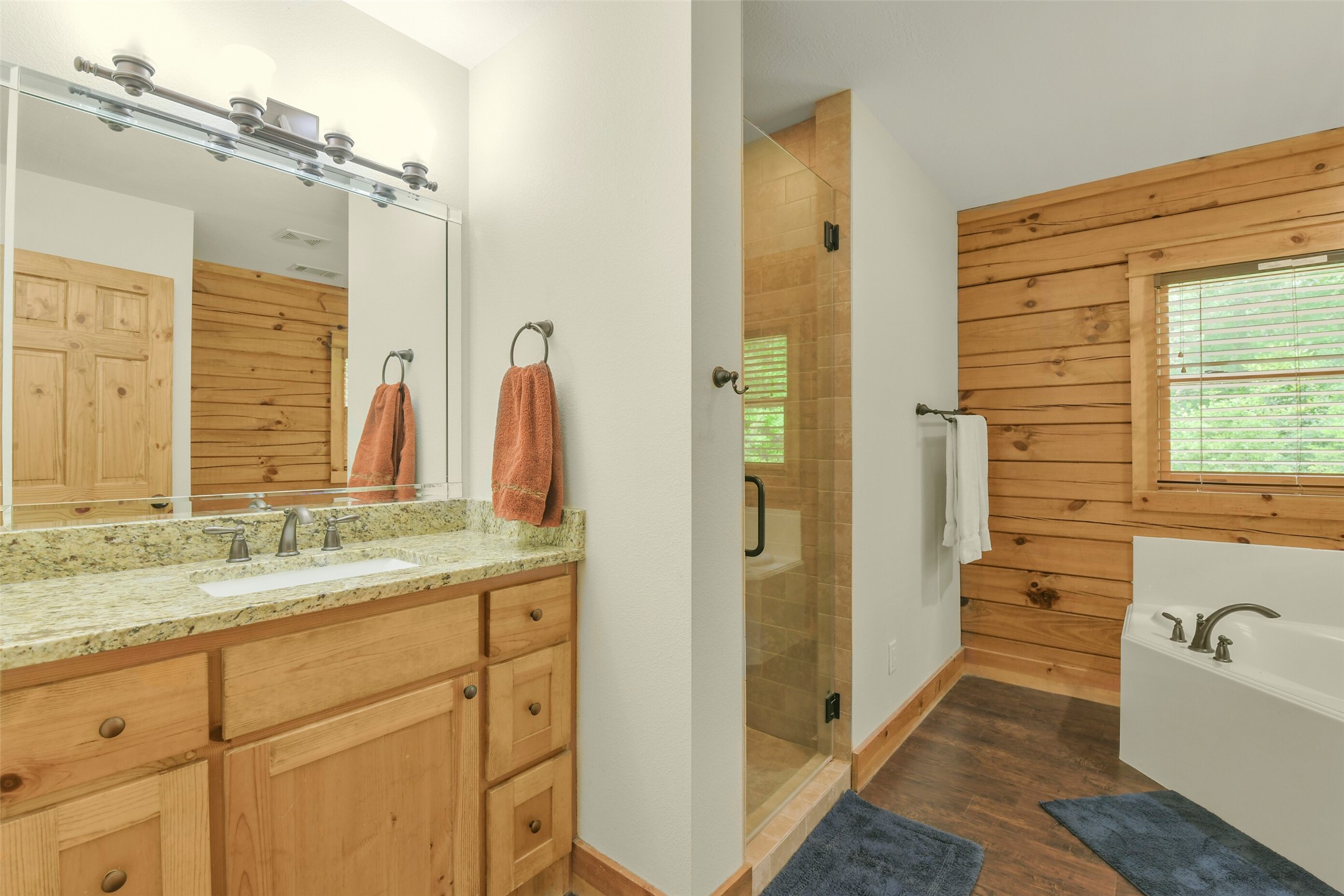 91 Bluejay Way Cleveland, TX 77327 - Photo 28 of 50 a bathroom with a granite countertop sink mirror and a bathtub