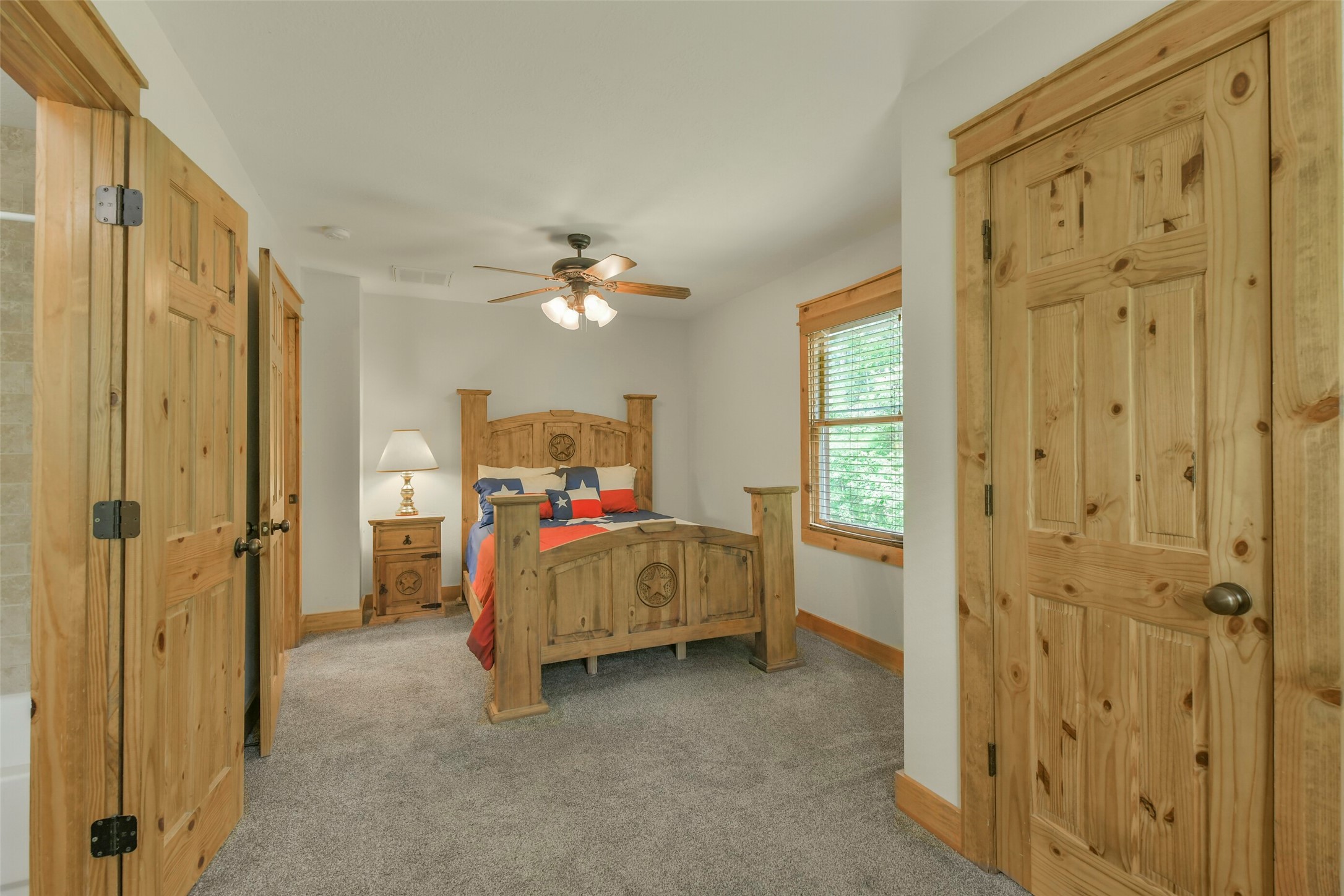 91 Bluejay Way Cleveland, TX 77327 - Photo 35 of 50 a bed room with a bed and a chandelier