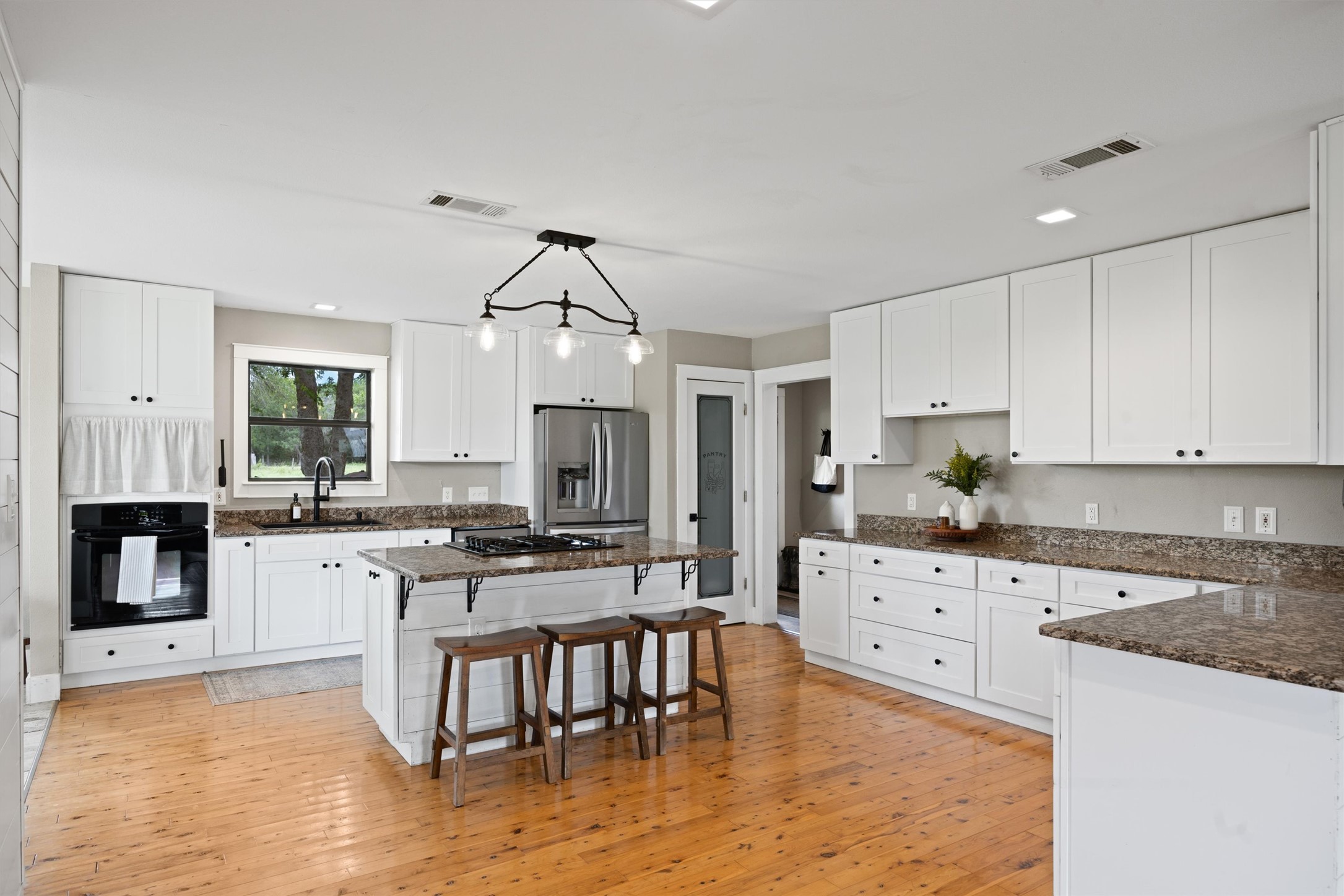 13590 Ranch Road 2338 Georgetown, TX 78633 - Photo 9 of 39 Check out all the counter space and cabinetry. Doorway to mudroom and to side deck is in the back corner of this photo.