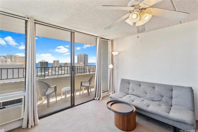 a living room with furniture and a floor to ceiling window