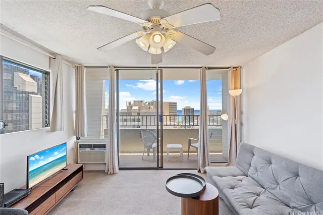 a living room with furniture and a floor to ceiling window