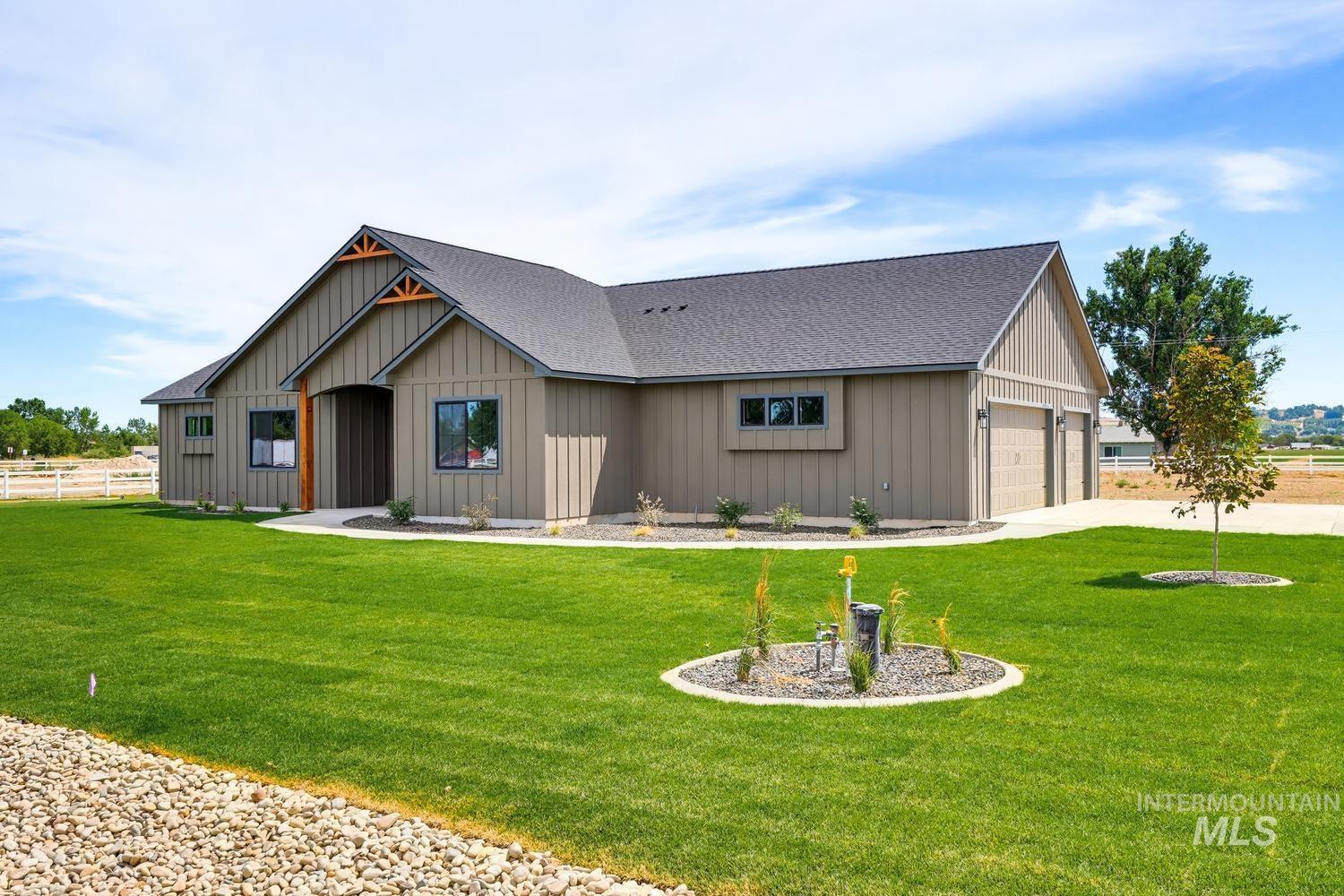 5054 Heritage Drive Marsing, ID 83639 - Photo 1 of 38 Modern farmhouse exterior featuring board and batten siding and architectural roofline with exposed wood elements