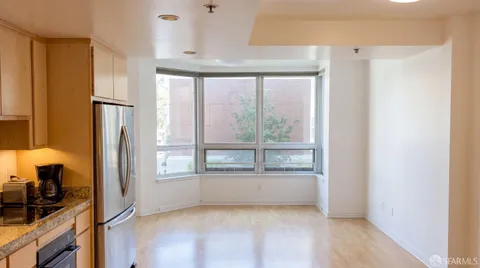 a view of a kitchen with a refrigerator and a window