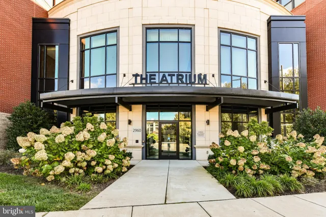 a front view of a house with a lot of flowers