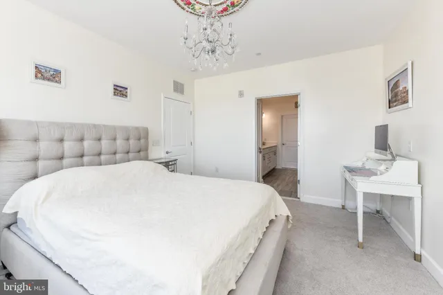 a bedroom with a bed and a table in it