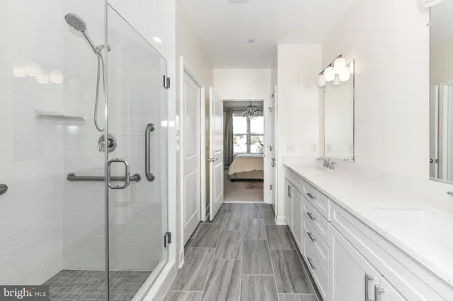 a bathroom with a double vanity sink mirror and shower