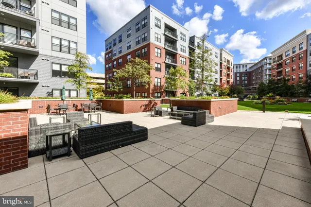a view of multiple house with yard and sitting area