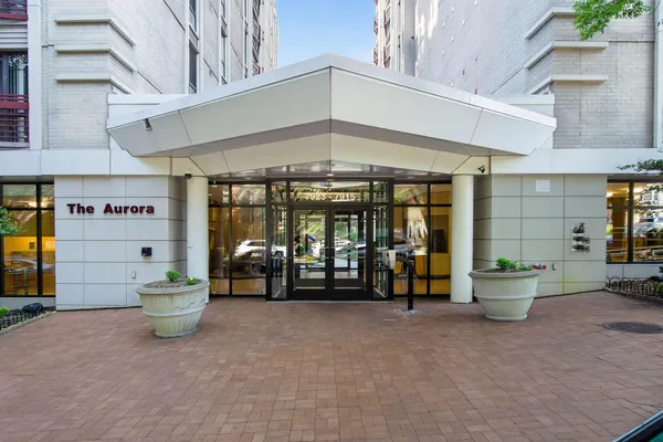 a front view of a building with outdoor seating