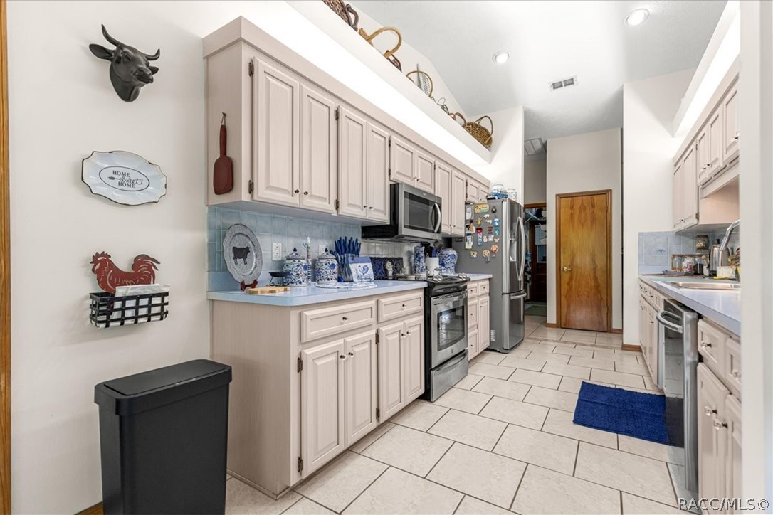 2964 South Cygnet Terrace Inverness, FL 34450 - Photo 14 of 67 a kitchen with stainless steel appliances granite countertop a refrigerator and a stove top oven