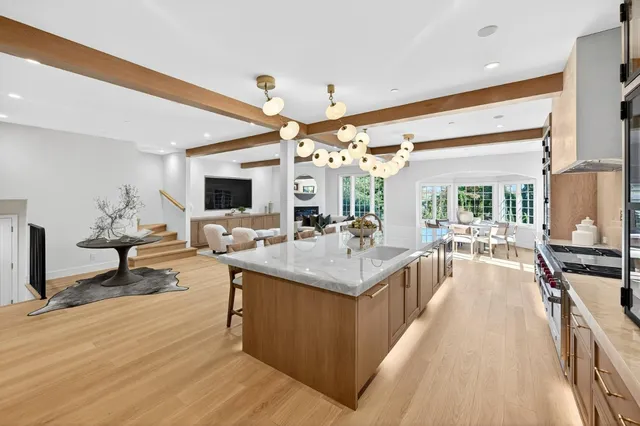 a view of living room with kitchen island furniture and a flat screen tv