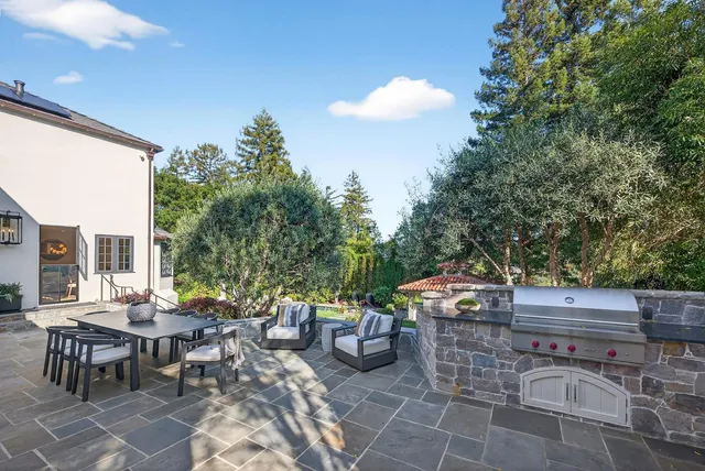 a view of a patio with table and chairs and potted plants