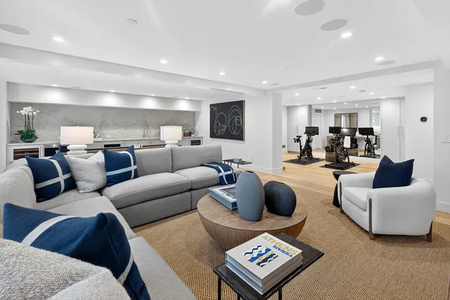 a living room with furniture and view of kitchen