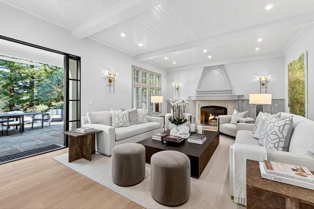 a living room with furniture large window and a fireplace