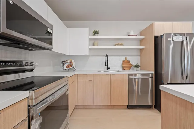 a kitchen with stainless steel appliances cabinets and a counter top space