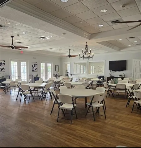 a view of a dining room with furniture a rug and wooden floor
