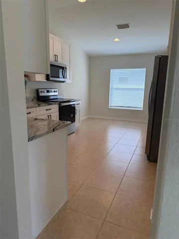 a kitchen with stainless steel appliances a stove a microwave and a refrigerator