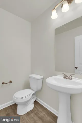 a white toilet sitting next to a bathroom sink