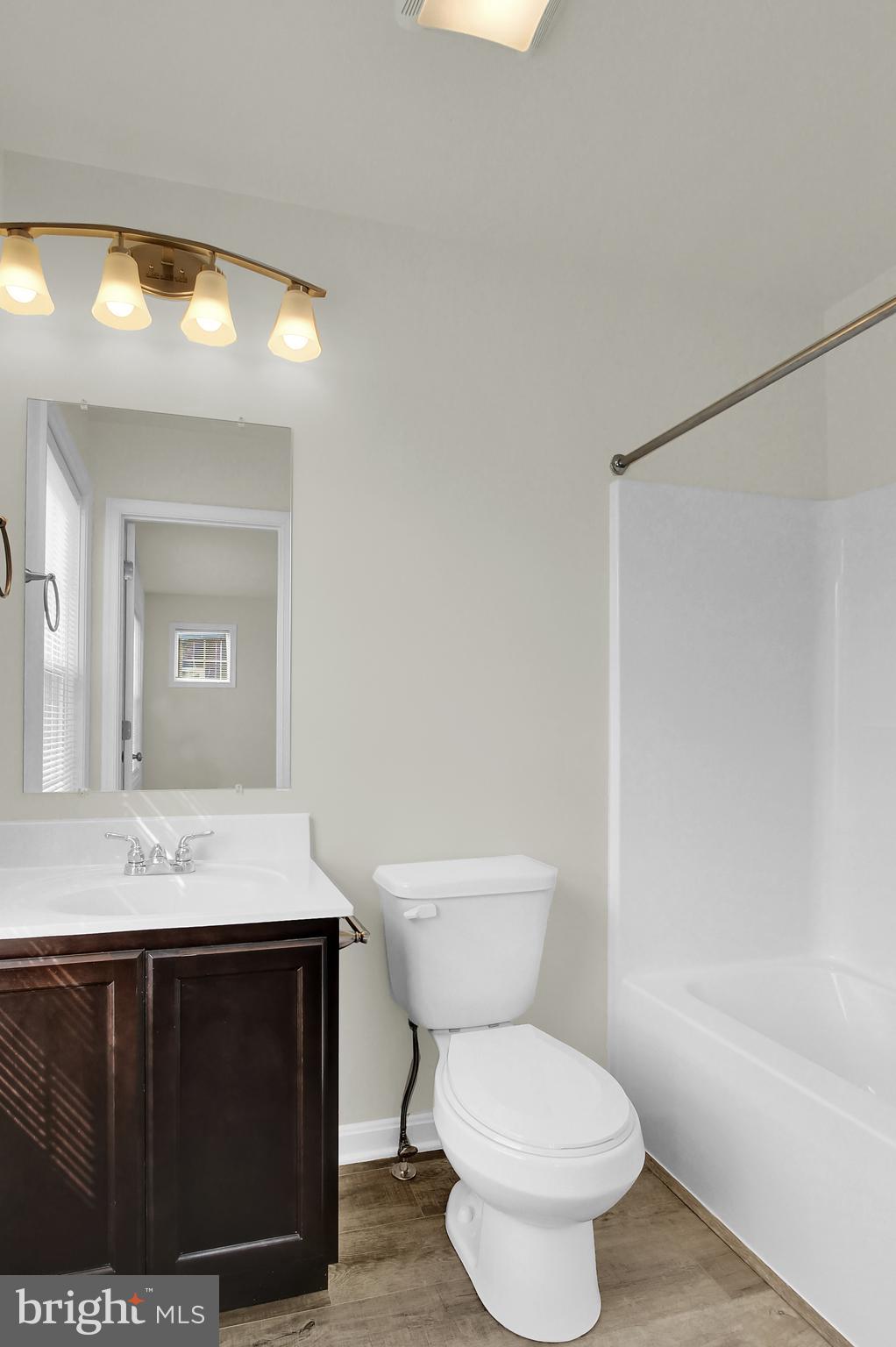 74 Brookside Avenue Hanover, PA 17331 - Photo 9 of 13 a bathroom with a sink a toilet a mirror and vanity