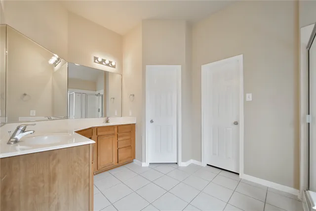 a spacious bathroom with a tub sink and mirror
