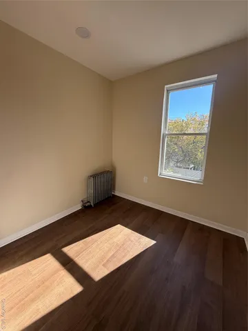 a view of an empty room and wooden floor
