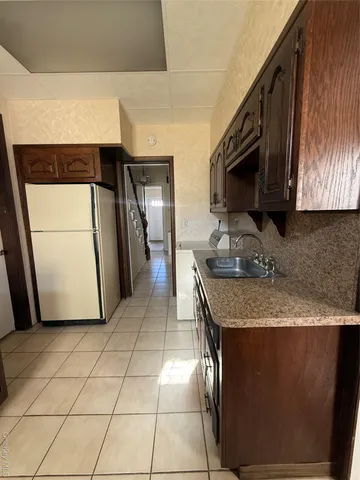 a kitchen with a sink a microwave and refrigerator