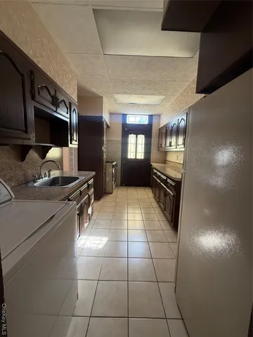 a kitchen with a sink a stove and a refrigerator