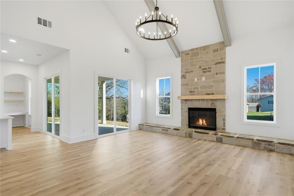 253 Northridge Road Ball Ground, GA 30107 - Photo 13 of 37 a view of an empty room with wooden floor fireplace and a window