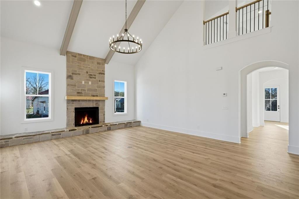 253 Northridge Road Ball Ground, GA 30107 - Photo 14 of 37 a view of an empty room with wooden floor fireplace and a window