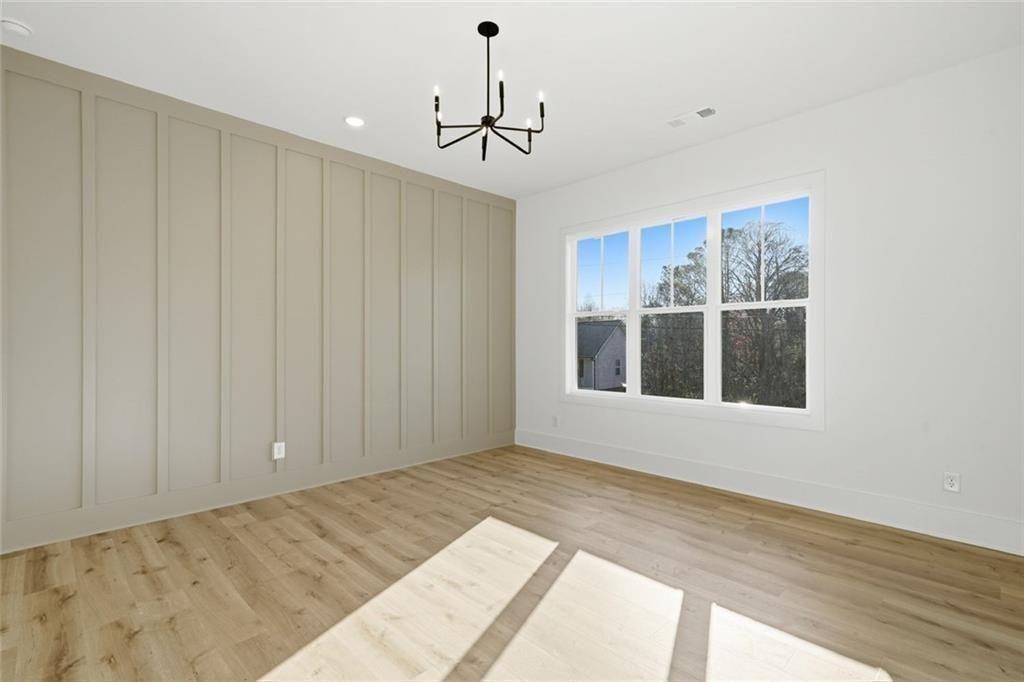 253 Northridge Road Ball Ground, GA 30107 - Photo 4 of 37 a view of a bedroom with wooden floor and windows
