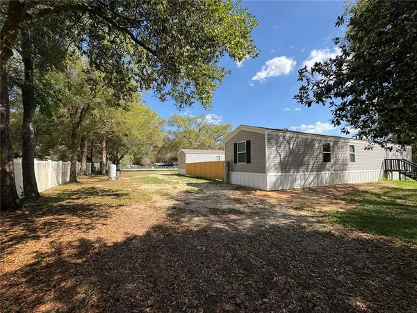 a backyard of apartments with large trees
