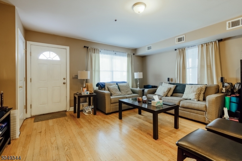 5 Maple Avenue Union, NJ 07088 - Photo 4 of 11 a living room with furniture and a wooden floor