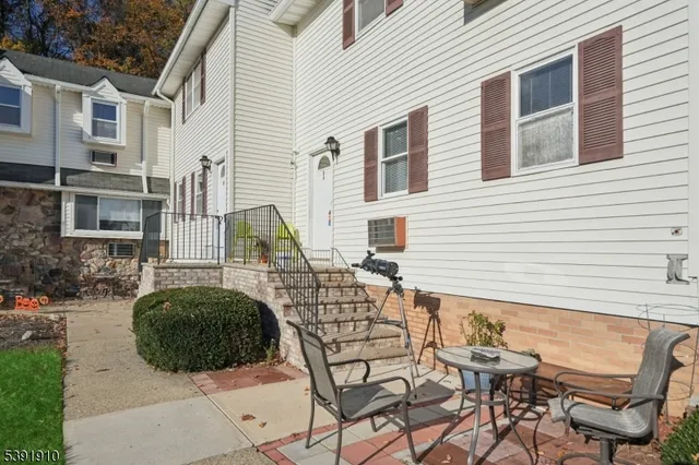 a view of a patio with table and chairs and potted plants
