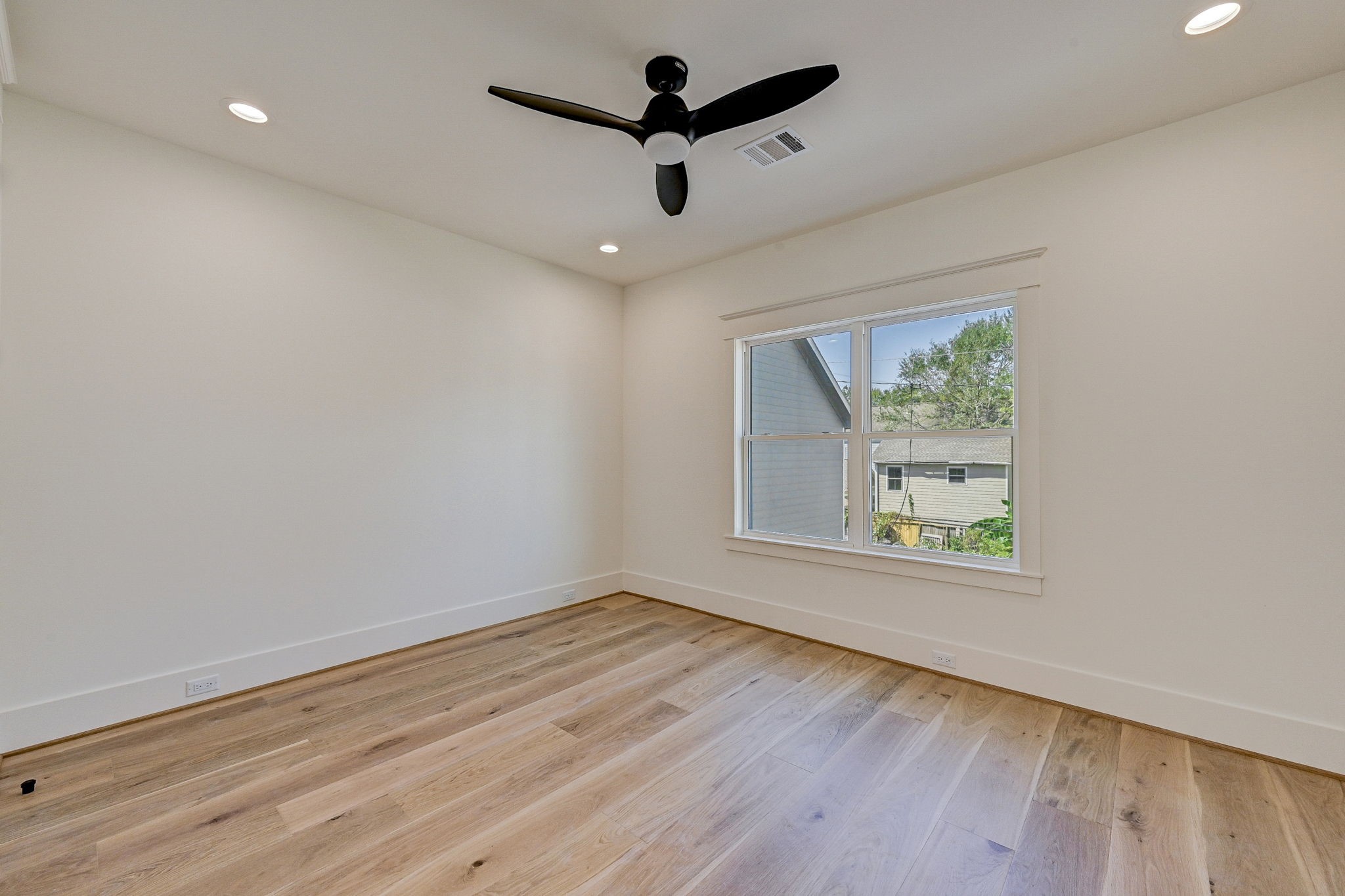 1520 Nicholson Street Houston, TX 77008 - Photo 33 of 39 an empty room with wooden floor ceiling fan and windows