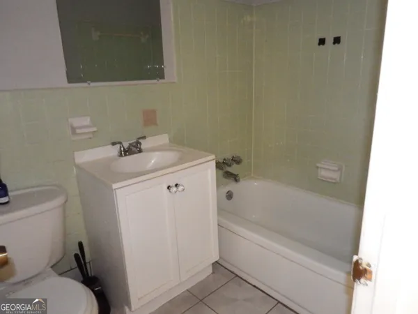a bathroom with a sink toilet and bathtub