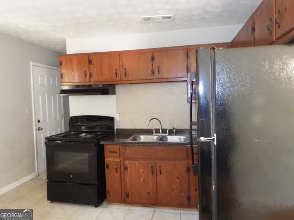 a kitchen with stainless steel appliances granite countertop a stove and a refrigerator