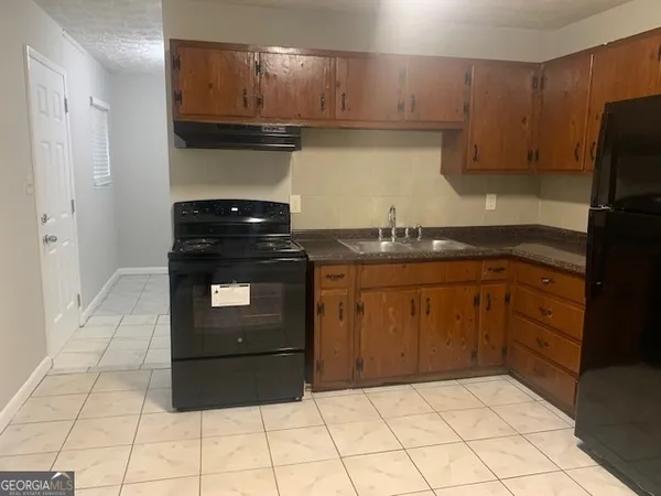 a kitchen with a stove and a refrigerator