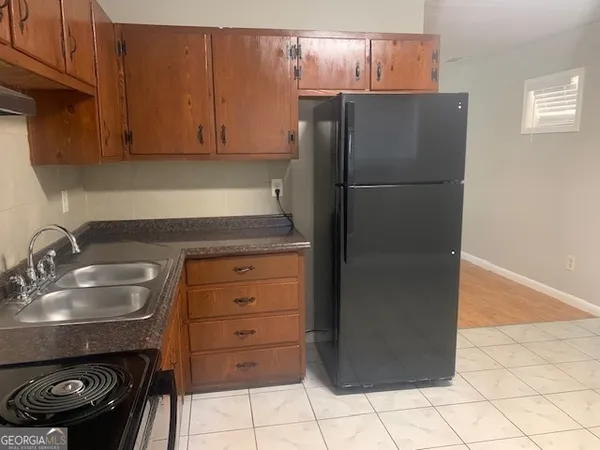 a kitchen with a refrigerator and a sink