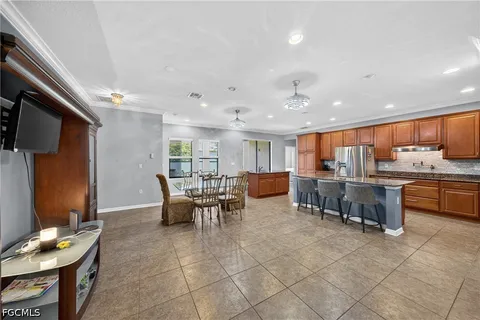 a kitchen with a dining table chairs and view kitchen