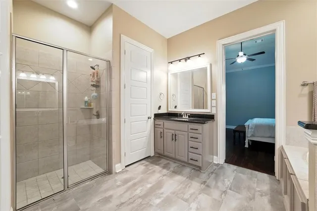 a bathroom with a tub sink shower and mirror