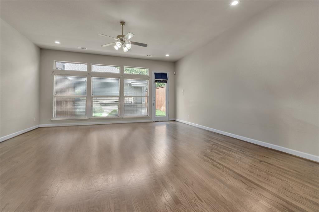 2407 Knight Street Dallas, TX 75219 - Photo 13 of 24 wooden floor in an empty room with a window