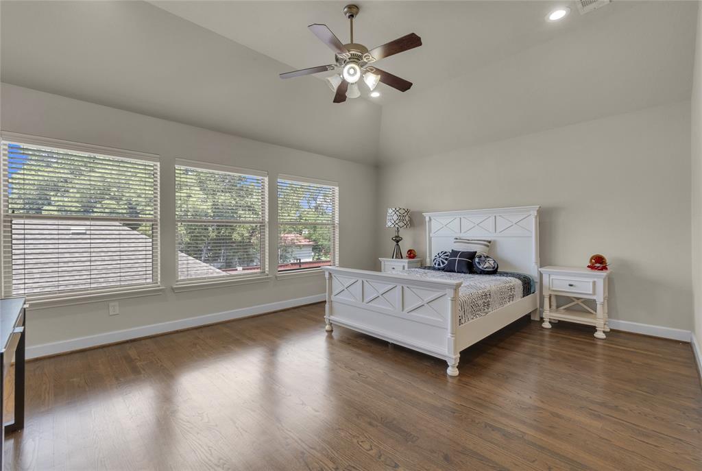 2407 Knight Street Dallas, TX 75219 - Photo 15 of 24 a bed room with a bed and a chandelier