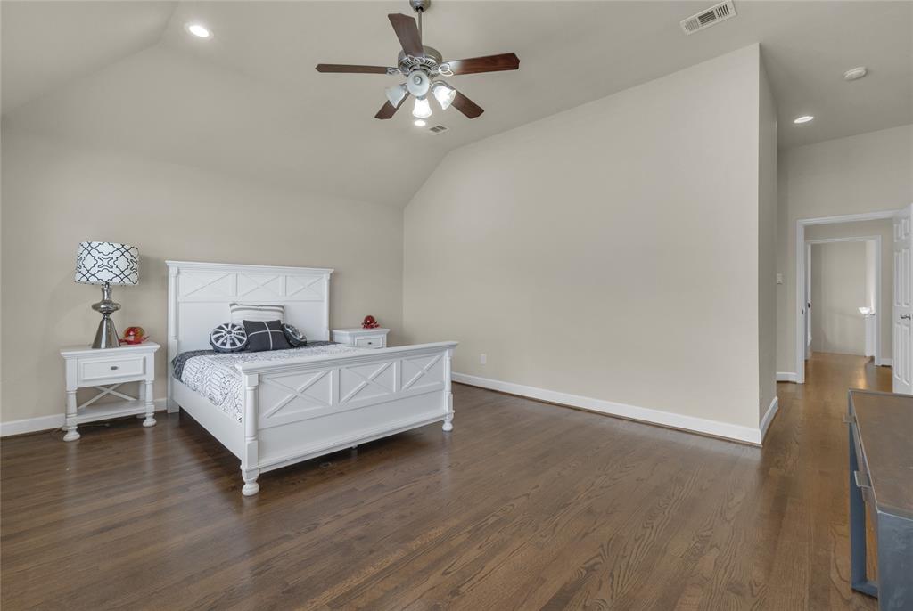 2407 Knight Street Dallas, TX 75219 - Photo 16 of 24 a bed room with furniture and a chandelier fan