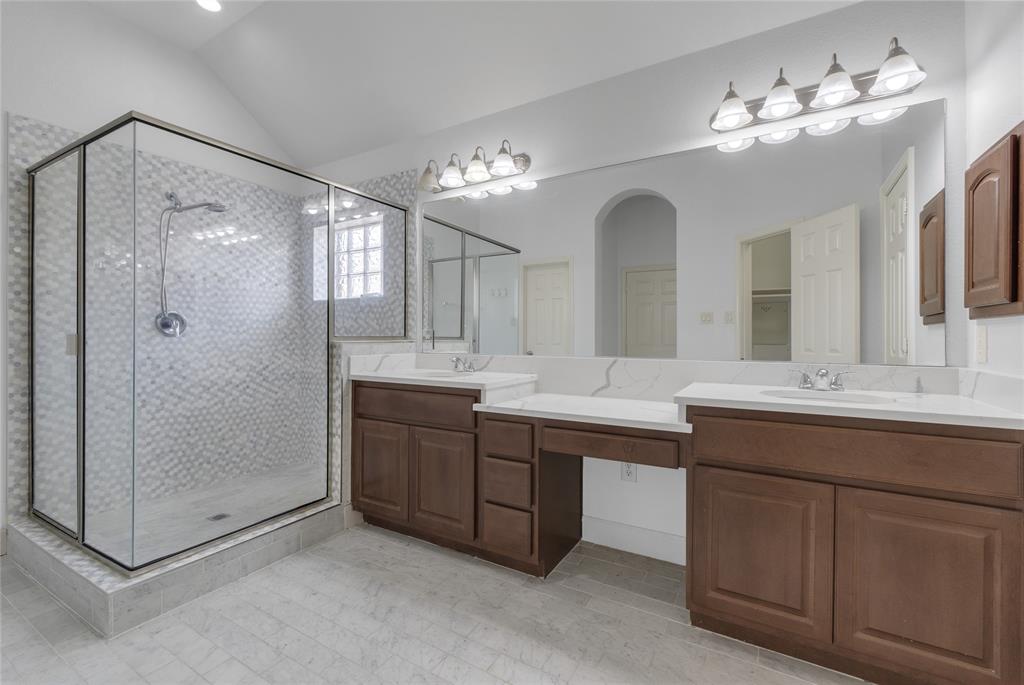 2407 Knight Street Dallas, TX 75219 - Photo 17 of 24 a bathroom with a double vanity sink mirror and shower