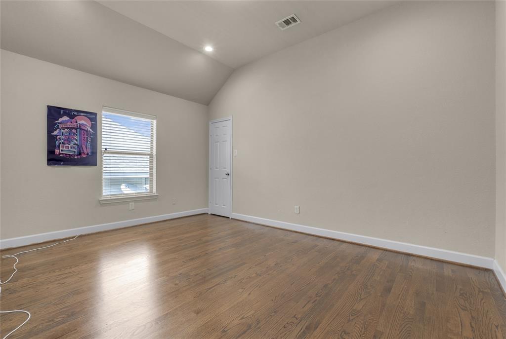 2407 Knight Street Dallas, TX 75219 - Photo 21 of 24 an empty room with wooden floor and windows