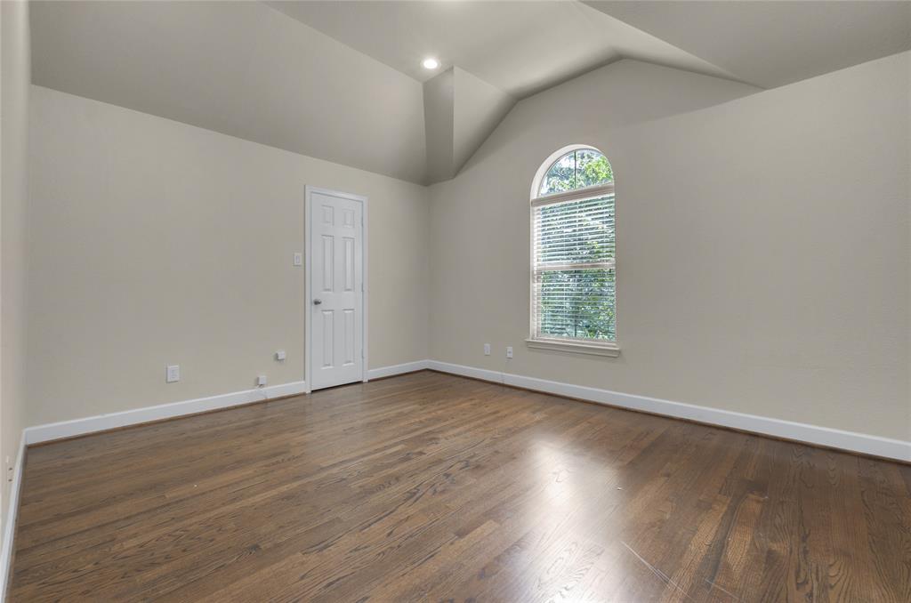 2407 Knight Street Dallas, TX 75219 - Photo 22 of 24 an empty room with wooden floors and window