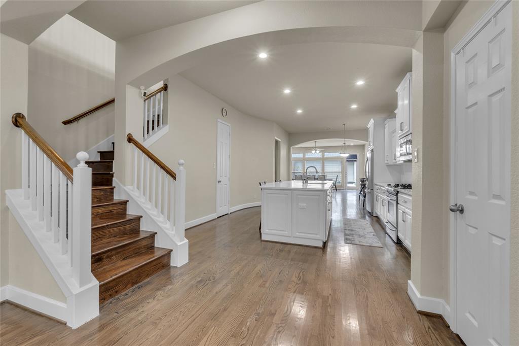2407 Knight Street Dallas, TX 75219 - Photo 6 of 24 a view of a hallway with wooden floor and staircase