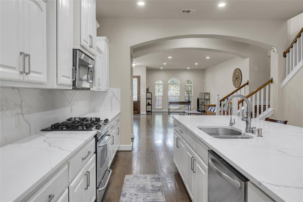 2407 Knight Street Dallas, TX 75219 - Photo 7 of 24 a kitchen with stainless steel appliances granite countertop a stove and a sink