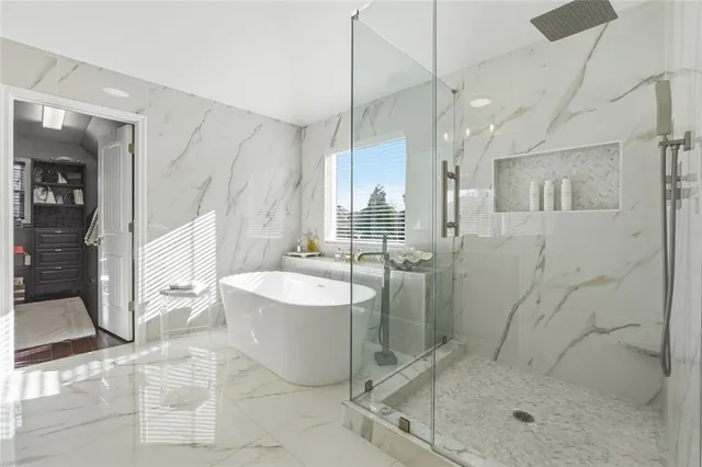 a living room with furniture fireplace and a large window